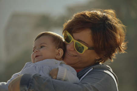 Mother and son strolling along looking at the horizon.の写真素材