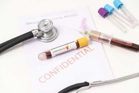 Scientist hold blood sample tube for Lambda Variant of SARS-CoV-2 test. Delta,Beta, Alpha, Gamma, Variants of Concern.India, brazil, UK, south africa virus with test tube and syringe background.の写真素材