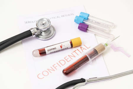 Doctor holding test tube with blood sample, closeup. Doping control.の写真素材