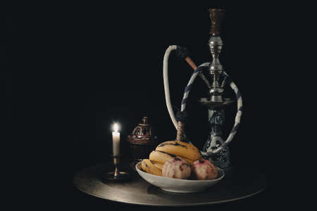 Shisha hookah together with fruit and candles. shisha concept.の写真素材