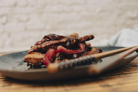 Chicken strips with red pepper in teriyaki sauce served.の写真素材