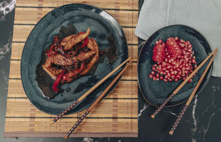 Chicken in soy sauce with red peppers, with pomegranate desserts.の写真素材