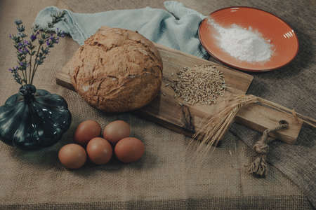 Bread dough with eggs and ingredients to make traditional rustic bread.の写真素材