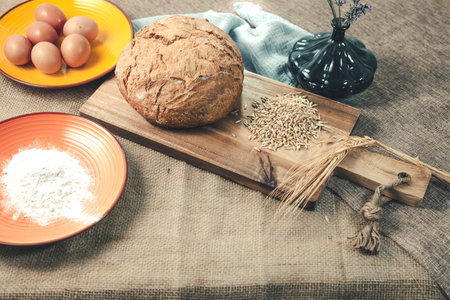 Bread dough with eggs and ingredients to make traditional rustic bread.の写真素材