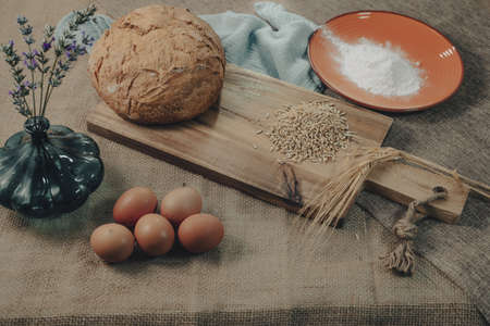 Ingredients for the preparation of the bread on a rustic tablecloth.の写真素材