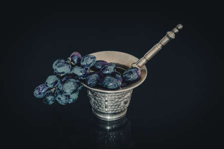 Bronze mortar with freshly harvested natural grapes.の写真素材
