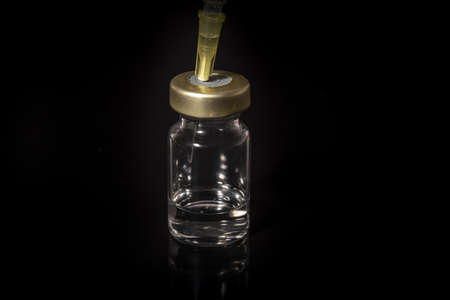 Syringe draws vaccine from ampoule. Close-up view.の写真素材