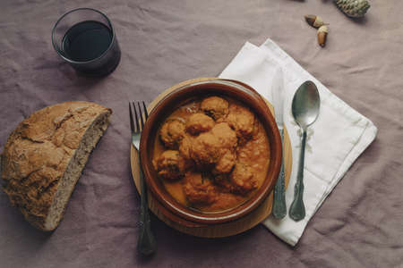 Meatball stew with tomato sauce in earthenware casserole dish.の写真素材