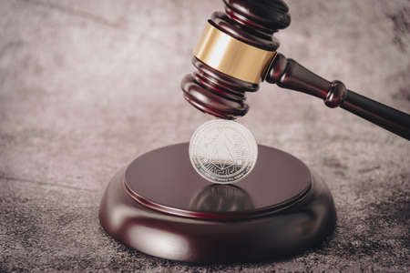 Cryptocurrency under judges gavel in foreground.の写真素材