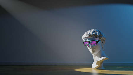 Statue. Isolated. Gypsum statue of Davids head. Man. Creative. Plaster statue of Davids head in blue sunglasses. Minimal concept art.の写真素材