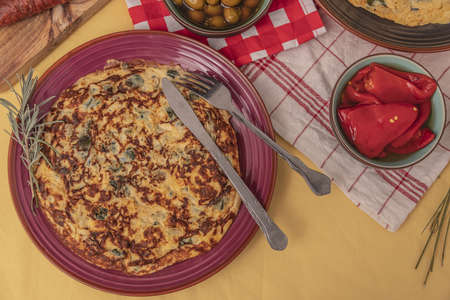 Courgette and onion omelette on a rustic table.の写真素材