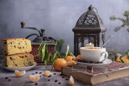 Close-up still life with a book, a geyser coffee maker, Christmas decor on the table. Selective focus.の写真素材