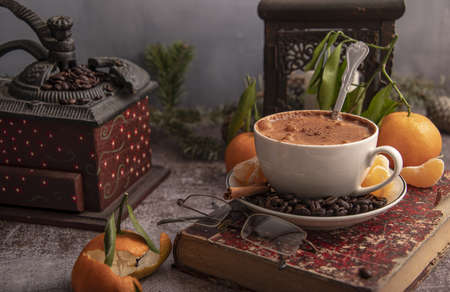 Close-up still life with a book, a geyser coffee maker, Christmas decor on the table. Selective focus.の写真素材