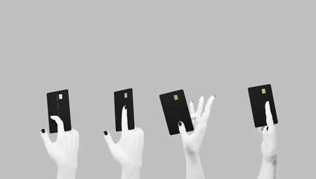 Female hand holding a bank card isolated on white background. 3d rendering.の写真素材