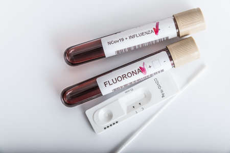 Blood samples of new variant OMICRON plus flu FLUORONE, covid19, coronavirus. Selective approach to the sample tube.の写真素材