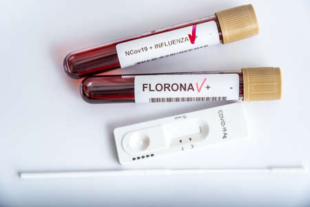 Blood samples of new variant OMICRON plus flu FLUORONE, covid19, coronavirus. Selective approach to the sample tube.の写真素材