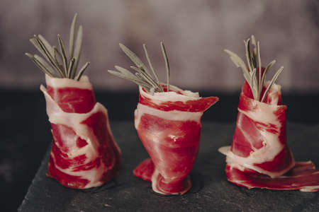 Spanish jamon Serrano, against a stone background.の写真素材