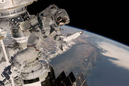The astronaut in a space suit, in an outer space, is engaged in repair of the space station. 3d rendering.の写真素材