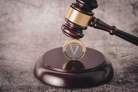 Cryptocurrency under judges gavel in foreground.の写真素材
