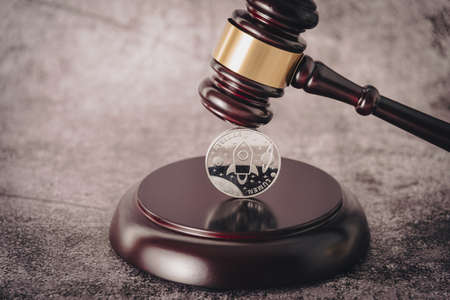 Cryptocurrency under judges gavel in foreground.の写真素材