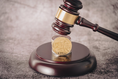 Cryptocurrency under judges gavel in foreground.の写真素材