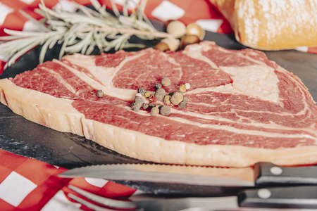 Variety of Raw Black Angus Prime meat steaks Machete, Blade on bone, Striploin, Rib eye, Tenderloin fillet mignon on wooden board.の写真素材