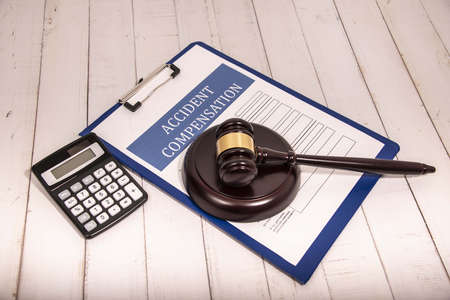 Compensation and judges gavel. Award of moral financial compensation for caused damage. Lawyer services. Workers rights protection. Raising wages. Determination of payments by a court order.の写真素材