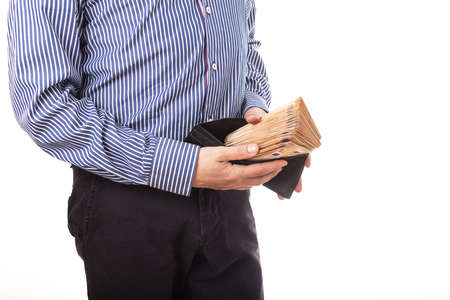Close up hand of a businessman holding banknote into pocket. It represents very profitable investment. The exchange of currencies with good returns. And money to buy debt securities increase revenue.の写真素材