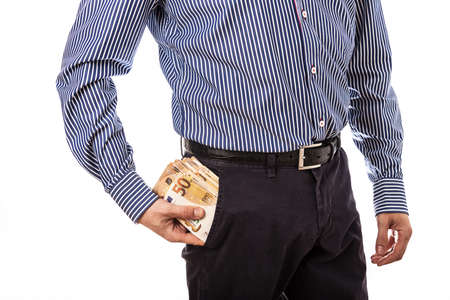 Man hand is putting money in the pocket.の写真素材