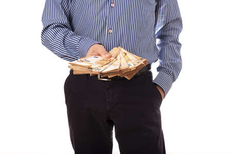 Man hand is putting money in the pocket.の写真素材