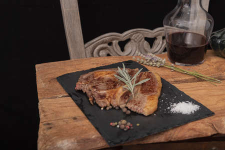 Beef on a slab of dark stone.の写真素材