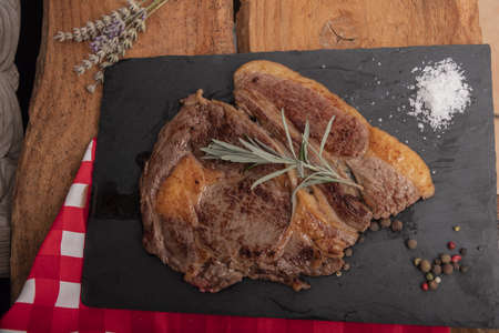 Beef on a slab of dark stone.の写真素材