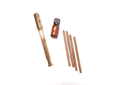 Alternative therapist applying moxibustion a traditional chinese medicine method. Doctor healing young patient with traditional asian medicine. Moxa stick alone. Extreme close up. Moxibustion.の写真素材