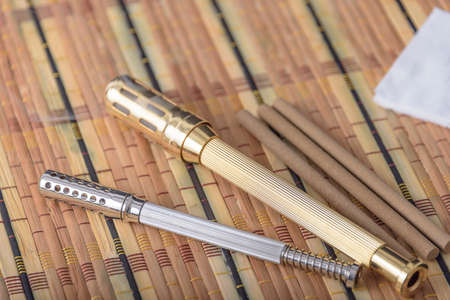Chinese copper moxibustion box with smoke on bamboo.の写真素材