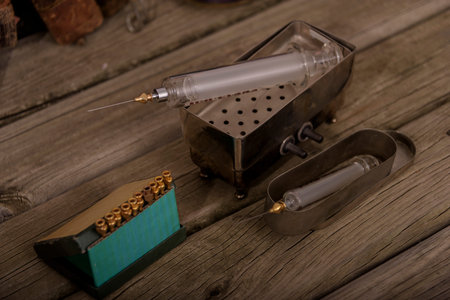 medicine and syringe on the wooden desk
