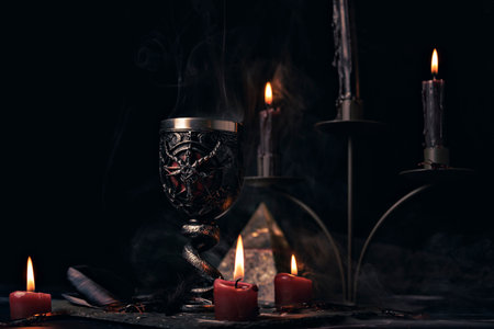 Witchcraft composition with candles, magic book and pentagram symbol. Altar for satanic rituals. Black magic and occult objects.の写真素材