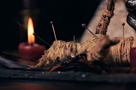 Voodoo doll in ritual scene close up, magic table with candles, witchcraft and spirituality concept.の写真素材