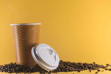 Take away coffee cup on yellow background. Coffee container mockup, blank spaceの写真素材