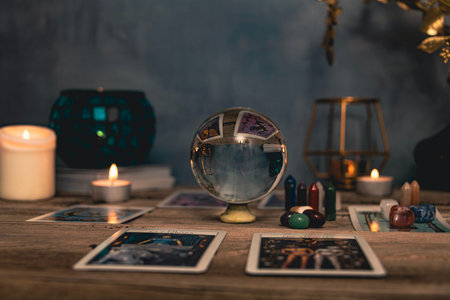 Tarot cards including The Fool and The Lovers alongside crystals and candles on a textured wooden...