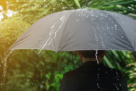 Young man shade umbrella on a rainy day.の写真素材