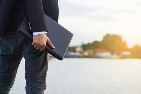 Close up of a businessman on a river background.の写真素材