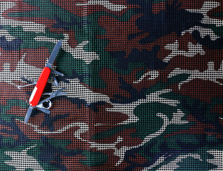 Multipurpose Knife on  camouflage net backgroundの写真素材