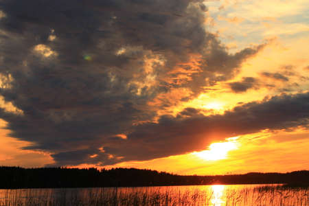 Beautiful sunset. Beautiful sunset and calm lake on a summer eveningの写真素材
