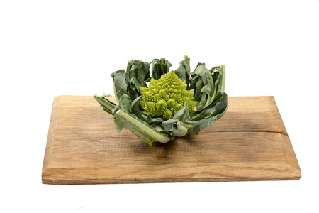 Romanesco cauliflower on a wooden board on a white backgroundの写真素材