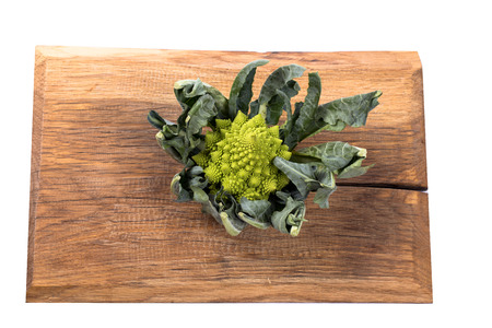 Romanesco cauliflower on a wooden board on a white backgroundの写真素材