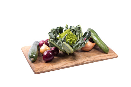 Selection of seasonal vegetables on a wooden board in white backroundの写真素材