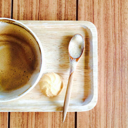 Drinking cup of coffee with cookies on wooden tableの素材