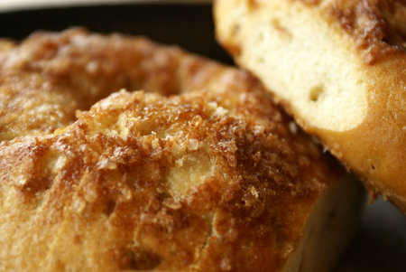 Sliced cinnamon crunch bagels , close up view showing topping detail