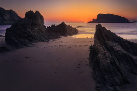 Rocky shore and sea during sunsetの写真素材