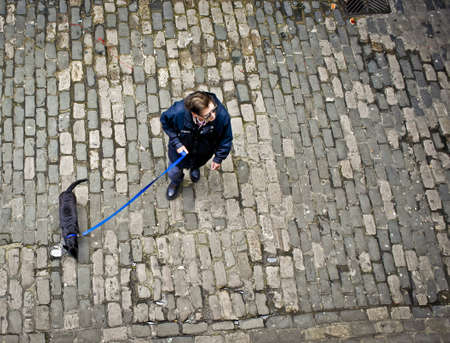 Overhead of a man walking his dog, Seattle, WA.のeditorial素材